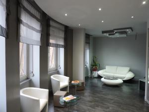 a living room with white furniture and windows at Alerion Centre Gare in Metz