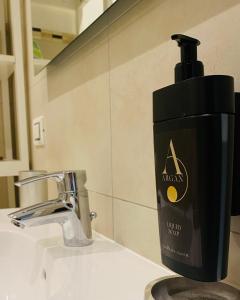 a black soap dispenser sitting on top of a sink at Venetian Mood in Venice