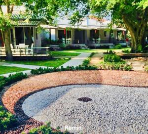 a gravel garden in front of a house at Da Kanda Villa Beach Resort in Thong Sala