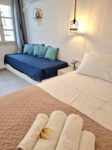 a bedroom with two beds with towels on them at Joannes Vacation Rooms in Adamas