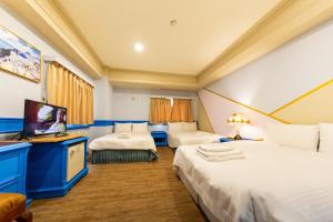 Postel nebo postele na pokoji v ubytování I HI Sanduo Travel Hotel