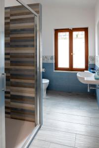 a bathroom with a shower and a toilet and a sink at Villa Luciana in Sant'Agnello