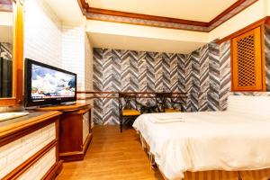 Postel nebo postele na pokoji v ubytování I HI Sanduo Travel Hotel