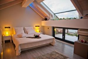 a bedroom with a bed and a large window at Seacret Apartments in Selianitika