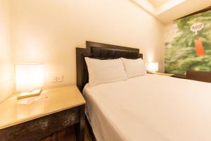 Postel nebo postele na pokoji v ubytování I HI Sanduo Travel Hotel