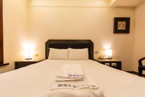 Postel nebo postele na pokoji v ubytování I HI Sanduo Travel Hotel