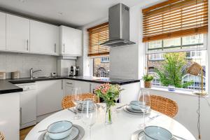 a kitchen with a table with a vase of flowers on it at Charming Studio Flat next to Holborn station in London