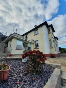 a house with a statue in front of it at Hillside in Ardmore