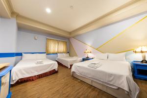 Postel nebo postele na pokoji v ubytování I HI Sanduo Travel Hotel