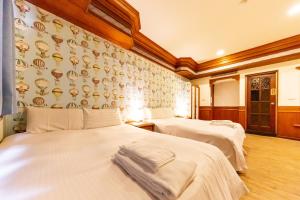 Postel nebo postele na pokoji v ubytování I HI Sanduo Travel Hotel