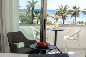 a room with a view of the beach from a hotel room at Pavlo Napa Beach Hotel in Ayia Napa