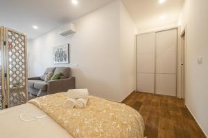 Posteľ alebo postele v izbe v ubytovaní Apartamentos DOM ROOM