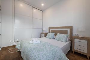 Posteľ alebo postele v izbe v ubytovaní Apartamentos DOM ROOM