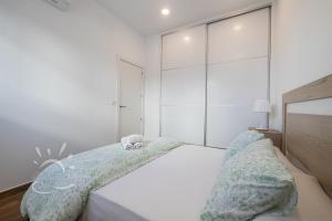 Posteľ alebo postele v izbe v ubytovaní Apartamentos DOM ROOM