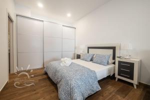 Posteľ alebo postele v izbe v ubytovaní Apartamentos DOM ROOM