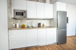 Kuchyňa alebo kuchynka v ubytovaní Apartamentos DOM ROOM