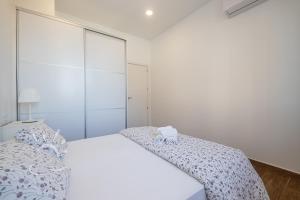 Posteľ alebo postele v izbe v ubytovaní Apartamentos DOM ROOM