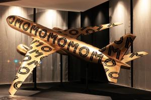 a wooden airplane with the words mondaynesday written on it at OMO Kansai Airport by Hoshino Resorts in Izumi-Sano