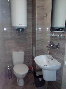 a bathroom with a toilet and a sink at Хостел Атлас - Hostel Atlas in Blagoevgrad