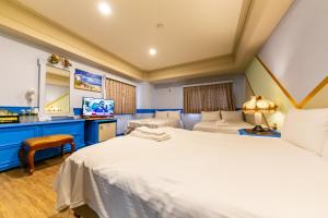Postel nebo postele na pokoji v ubytování I HI Sanduo Travel Hotel