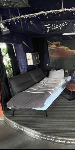 a bed in the back of a tent at Musikbühne Flieger - das Konzept - Loften in einer Kneipe in Tettnang