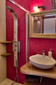 a bathroom with a sink and a mirror at Villa Athina in Megála Khoráfia