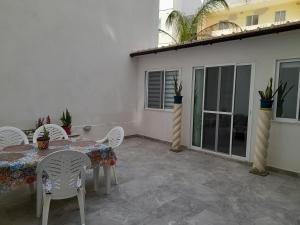 a patio with a table and chairs and a building at Spacious and Modern Apartment Near to the Sea in St. Paul's Bay