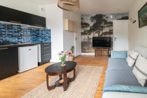 a living room with a couch and a table at L'INDOCHINE in Morlaix