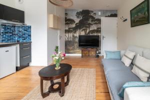 a living room with a couch and a table with flowers on it at L'INDOCHINE in Morlaix