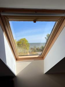 a window in a room with a view of the ocean at Preila 69 Apartamentai in Preila