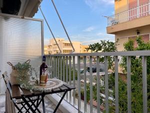 a table on a balcony with a bottle of wine at Modern Apartment in Kos Town, Walking Distance to the Beach - No 4 in Kos Town