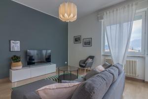 a living room with a couch and a tv at Como Borghi Apartment by Wonderful Italy in Como