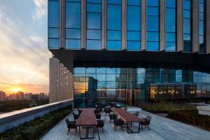 a building with tables and chairs on top of it at Sheraton Beijing Lize Hotel in Beijing