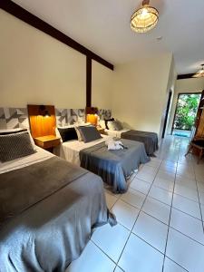 Cama ou camas em um quarto em Recanto Verde Praia Hotel Juquehy