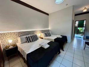 Cama ou camas em um quarto em Recanto Verde Praia Hotel Juquehy