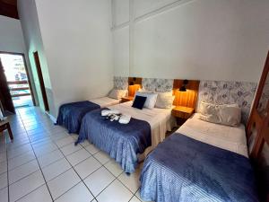 Cama ou camas em um quarto em Recanto Verde Praia Hotel Juquehy