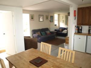 a kitchen and living room with a table and chairs at peaceholm at cromer in Cromer
