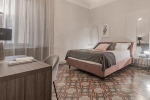 a bedroom with a bed and a table and a desk at [5 min Historic Center] Luxury White Lotus Mansion in Como