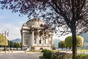 a building with a dome in a park at [5 min Historic Center] Luxury White Lotus Mansion in Como