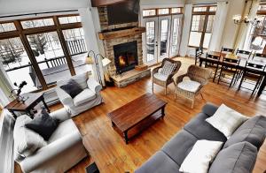a living room with a couch and a fireplace at Chalet 9023 Chemin des Alpages by Les Chalets Alpins in Stoneham