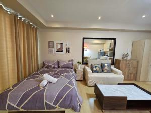 a bedroom with a bed and a couch at N place at Soho Central in Manila +81 photos