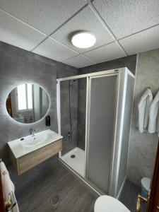 a bathroom with a shower and a sink and a toilet at Hostal Calderón de la Barca in Zalamea de la Serena