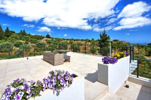 A garden outside Villa Kallos by PosarelliVillas
