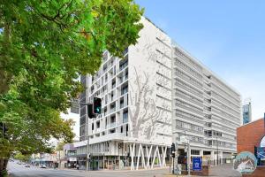 a large white building on a city street with a traffic light at Aircabin - Chatswood - Walk to station - 2 Beds Apt in Sydney