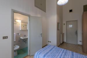 a bathroom with a bed and a sink and a toilet at Antica Dimora Sant'Anna in Florence