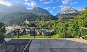 a view from the balcony of a house with mountains at Chasa Miramunt 6 in Scuol