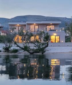 a house sitting on top of a body of water at Infinity Residence in Trogir