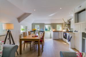 a kitchen and dining room with a table and chairs at Trevadlock Manor Self Catering Cottages in Launceston