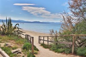a path leading to a beach with a fence at Holiday Home Arzilli in Follonica