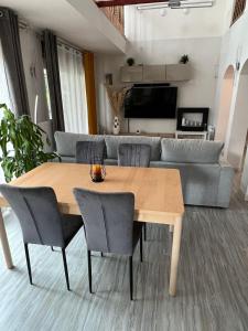 a living room with a wooden table and a couch at VILLA TOMILLARES in Los Tomillares